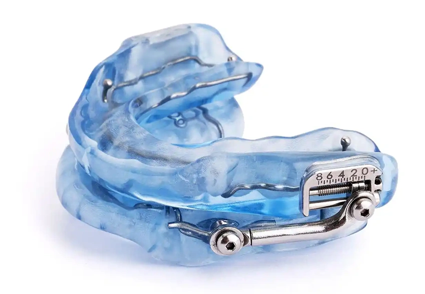 Custom oral appliance for sleep apnea treatment on white background