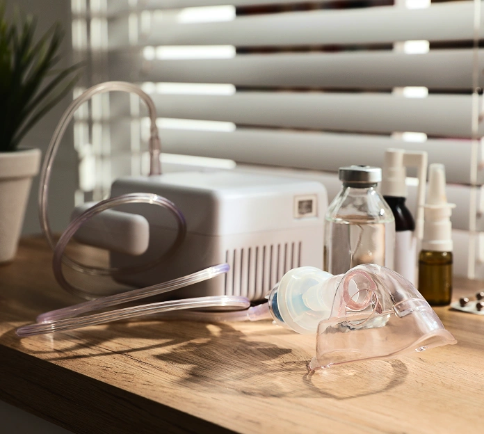 CPAP machine with tubing and mask on a wooden nightstand